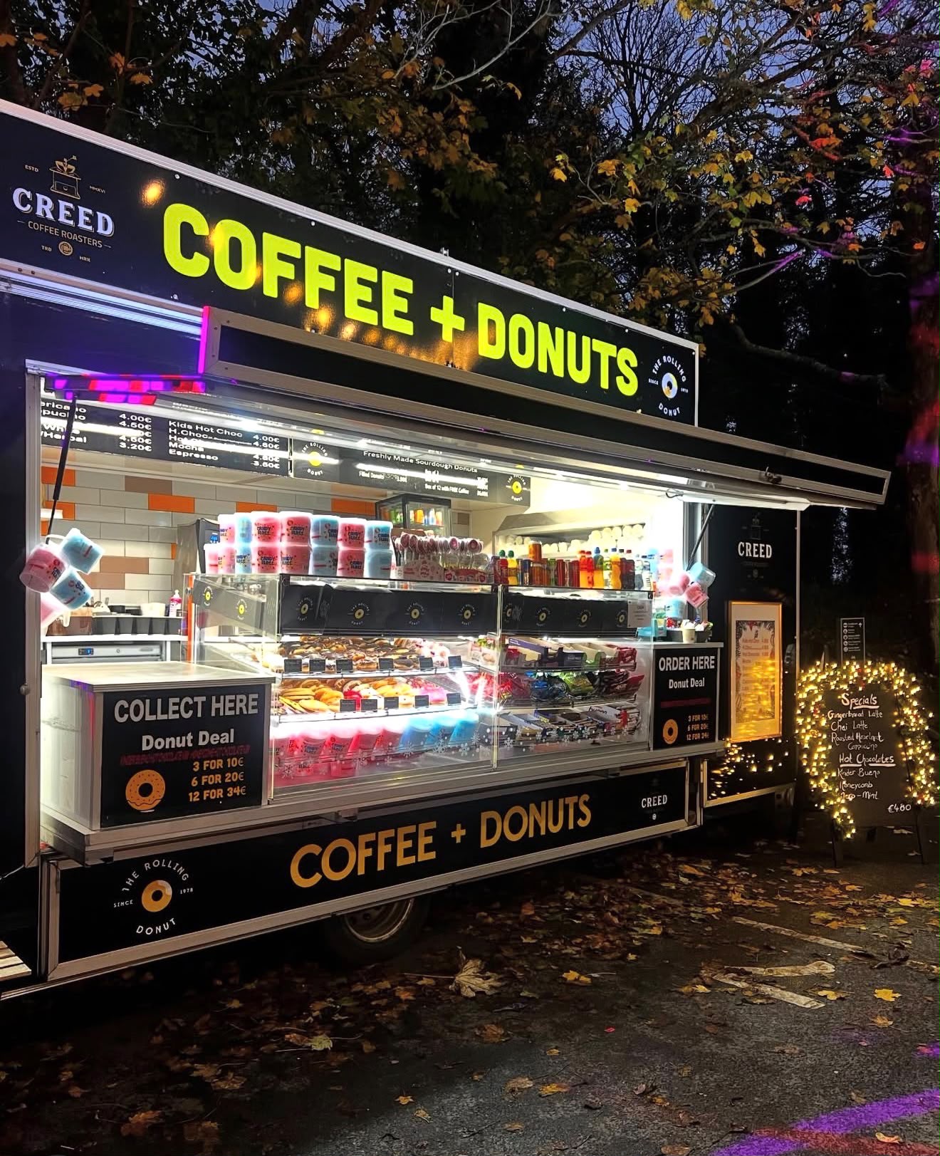 Coffee & Donuts van lit up at an evening event